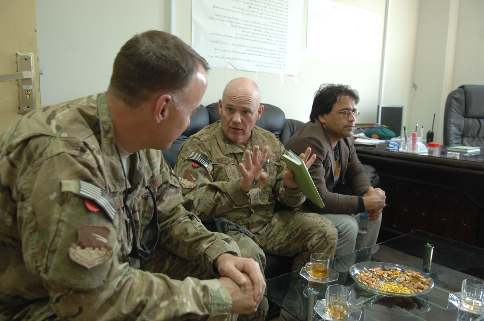 Chief Master Sgt. John Hoffman, 438th Air Expeditionary Wing command chief, discuss enlisted issues with Chief Master Sgt. Cliff Herndon, 738 Air Expeditionary Advisory Group superintendent, during a battlefield circulation April 5, at Kandahar Airfield, Afghanistan. (U.S. Air Force photo by Tech. Sgt. Jeremy Larlee)