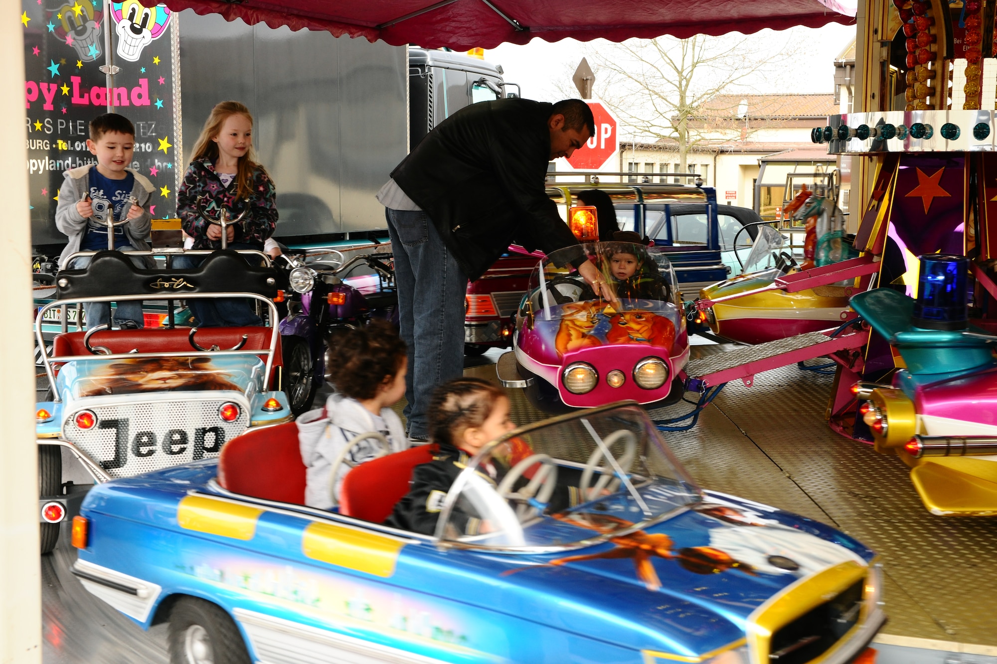 SPANGDAHLEM AIR BASE, Germany – Children ride a merry-go-round during the Month of the Military Child Block Party at the Skelton Memorial Fitness Center here April 7. More than 25 games and activities were offered, including gymnastics and hula dancing performances, as well as food, snacks and drinks for children to enjoy. The event was sponsored by the local Masonic community and 52nd Force Support Squadron to support Airmen and their families. (U.S. Air Force photo by Airman 1st Class Dillon Davis/Released)