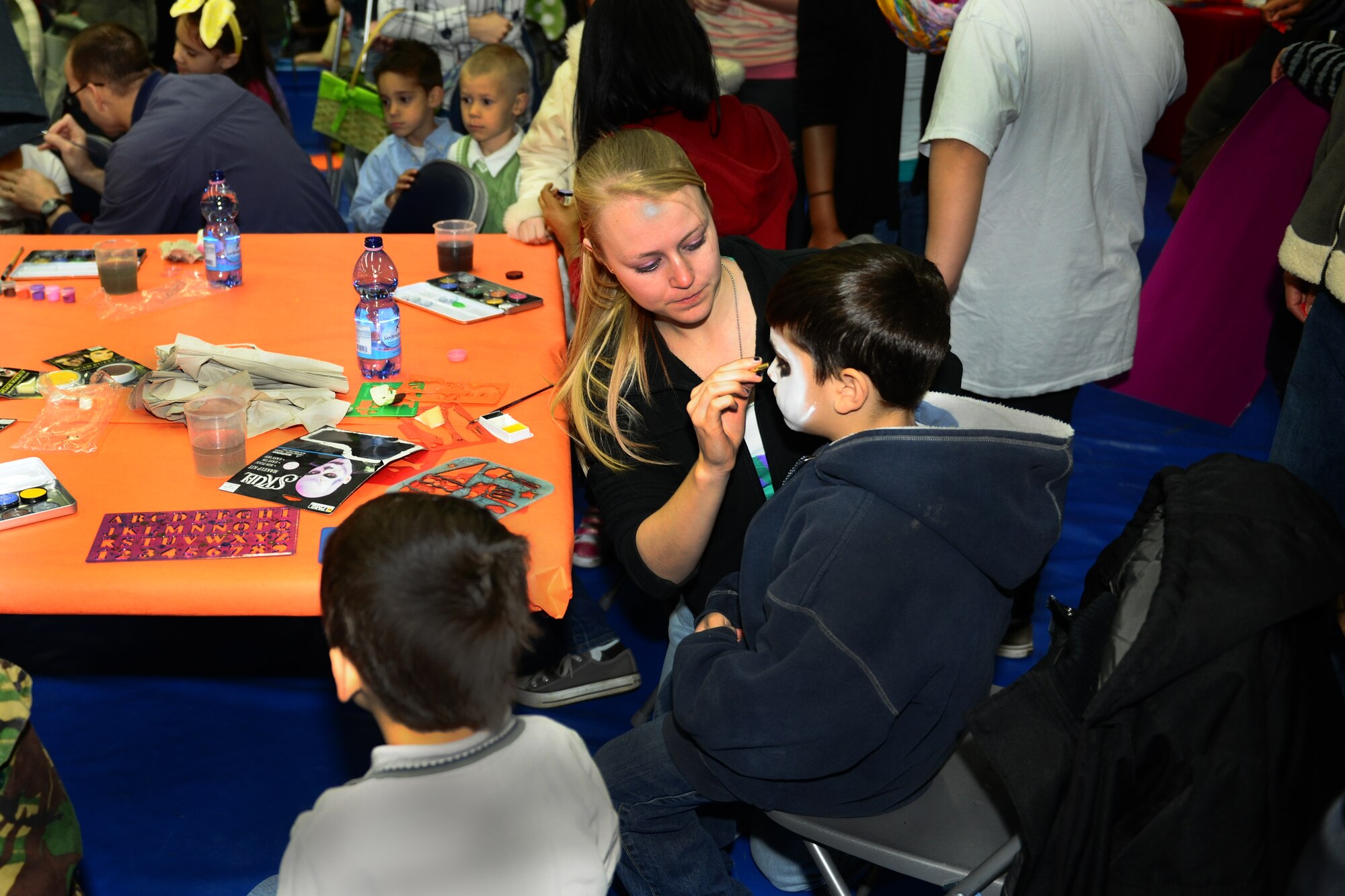 SPANGDAHLEM AIR BASE, Germany – Volunteers paint children’s faces during the Month of the Military Child Block Party at the Skelton Memorial Fitness Center here April 7. More than 25 games and activities were offered including gymnastics and hula dancing performances, as well as food, snacks and drinks for children to enjoy. The event was sponsored by the local Masonic community and 52nd Force Support Squadron to support Airmen and their families. (U.S. Air Force photo by Airman 1st Class Dillon Davis/Released)
