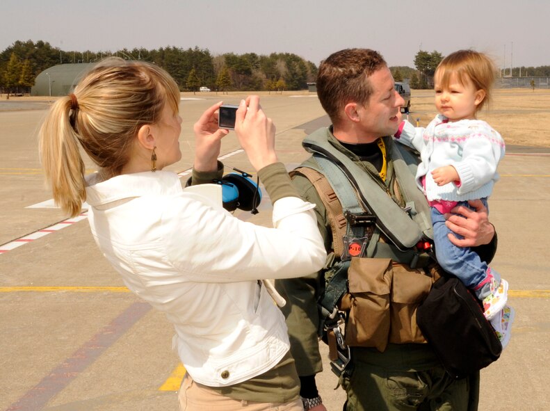 U.S. Air Force Maj. David Paulus, 14th Fighter Squadron assistant director of operations, meets with his family after returning from Operational Noble Eagle at Misawa Air Base, Japan, April 10, 2012. The 14th Fighter Squadron assisted the Alaskan North American Aerospace Defense Command region with its mission. (U.S. Air Force photo by Airman 1st Class Kaleb Snay/Released)