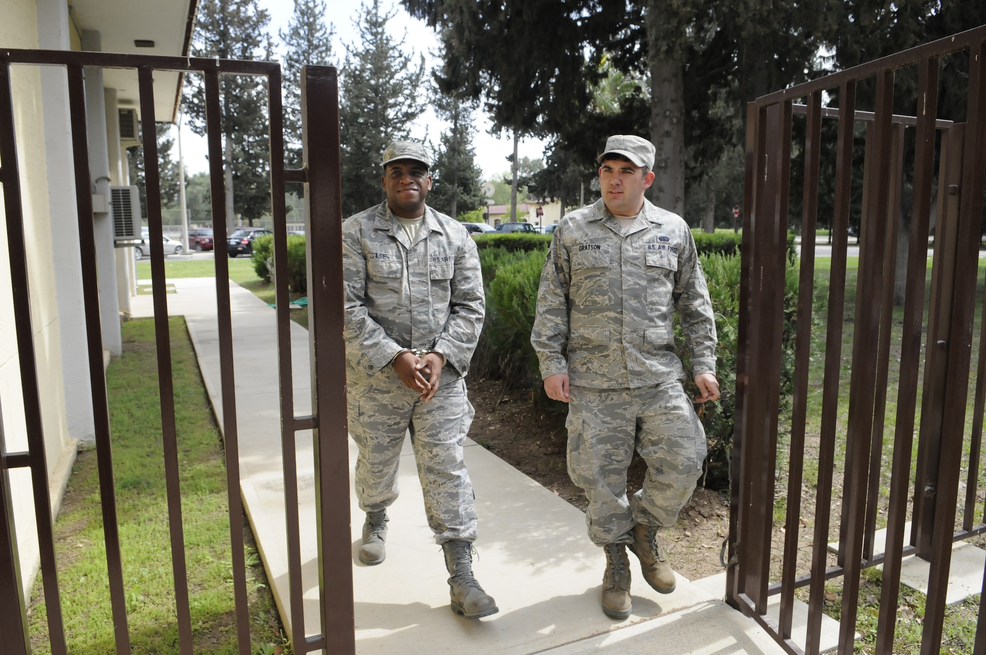 Master Sgt. Xzabriel Lee, 39th Logistics Readiness Squadron, left, is escorted by Senior Airman Joe Gratson, 39th Communications Squadron, to the jailthon during AFN Incirlik's Air Force Assistance Fund Telethon April 5, 2012, at Incirlik Air Base, Turkey. The telethon involved an auction of goods and services from local vendors, as well as faux arrests and bail bonds, which raised more than $6,000 for the AFAF in 12 hours. (U.S. Air Force photo by Staff Sgt. Kali L. Gradishar/Released)
