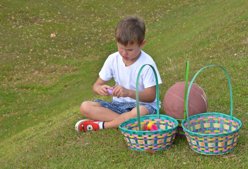 ANDERSEN AIR FORCE BASE, Guam-Andersen children search for eggs during the "EASTER EGGS-TRAVAGANZA" April 7 at the Andersen Youth Center field.  More than 5,000 candy-filled eggs were hidden for the children to find.  There were also other springtime activities such as face painting, caribou riding, games and various booths and demonstrations for all ages to enjoy.  (U.S. Air Force photo by Senior Airman Veronica McMahon)  
  

