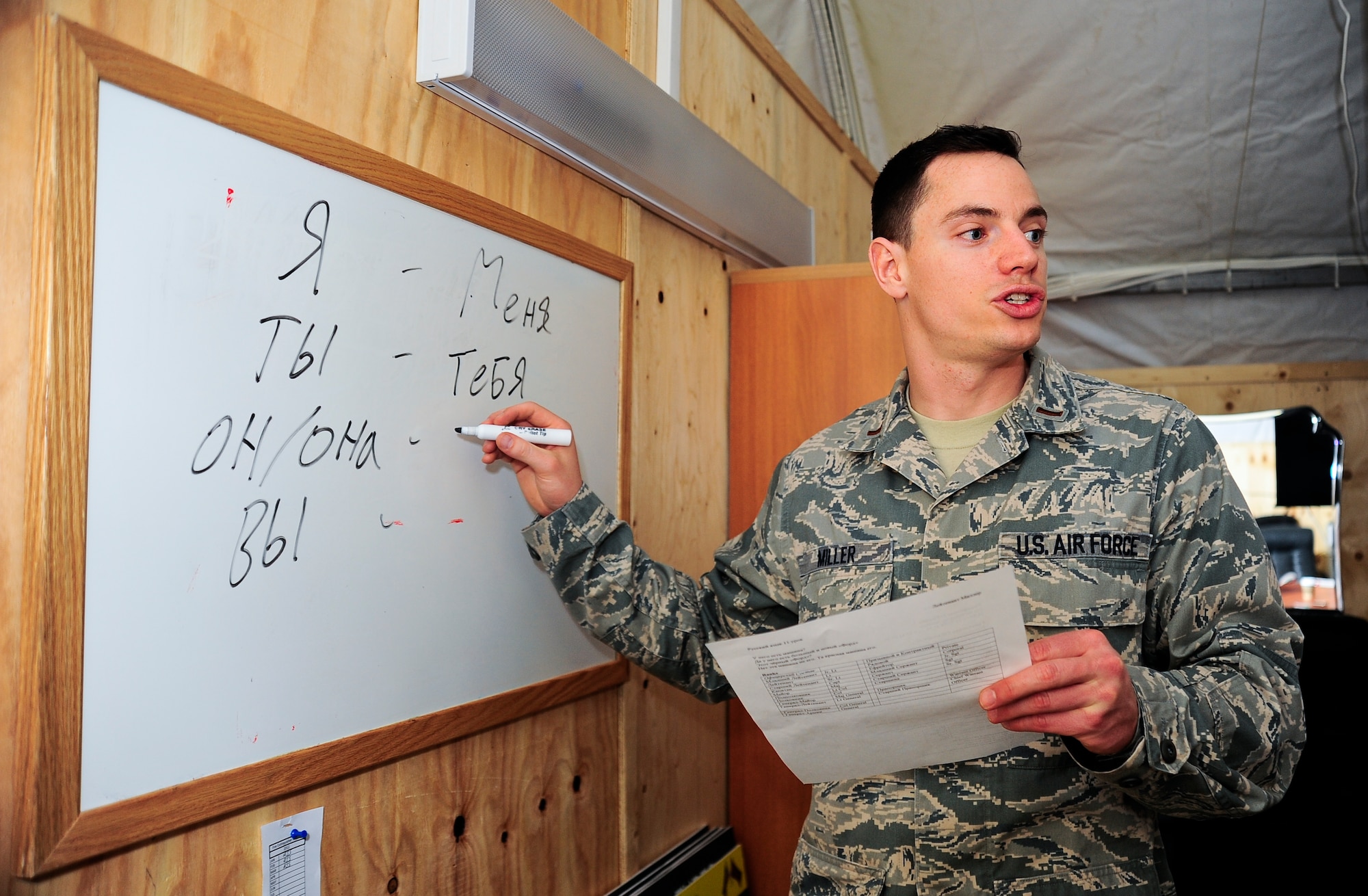 Second Lt. Justin Miller teaches "possessives" of the Russian language April 5, 2012, at the Transit Center at Manas, Kyrgyzstan. Miller teaches a basic Russian language class twice a week at the Theater Security Cooperation division to enable service members to engage in basic Russian conversations. Miller is the 376th Air Expeditionary Wing TSC host nation liaison branch chief and is deployed here from Beale Air Force Base, Calif. (U.S. Air Force photo/Staff Sgt. Angela Ruiz)
