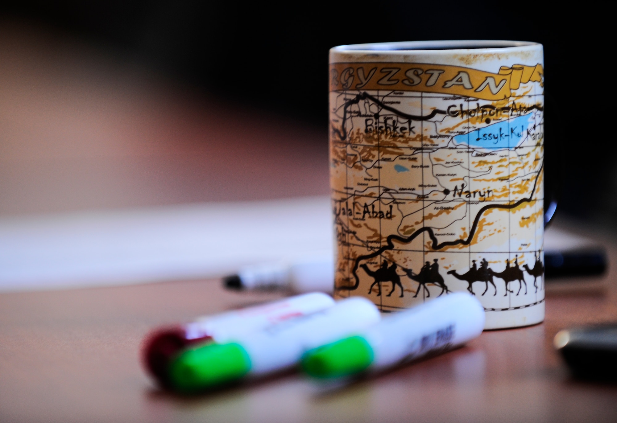 The basic Russian language instructor's coffee cup sits on a table April 3, 2012, at the Transit Center at Manas, Kyrgyzstan. The cup is decorated with a map of Kyrgyzstan. The Russian class is designed to enable service members to engage in basic Russian conversations. (U.S. Air Force photo/Staff Sgt. Angela Ruiz)