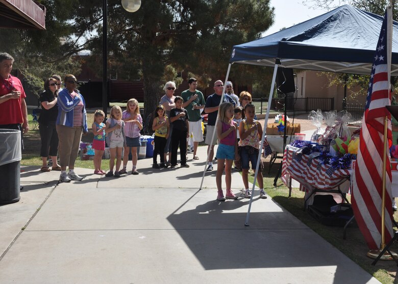 Members of the U.S. Army Corps of Engineers Los Angeles District team and their families recite the Pledge of Allegiance before the 2012 Engineer Day Celebration held in Phoenix at the McCormick-Stillman Railroad Park April 6. The Arizona-Nevada Area Office holds the celebration earlier than the official June timeframe in order to allow for more participation before the Arizona summer sets in.