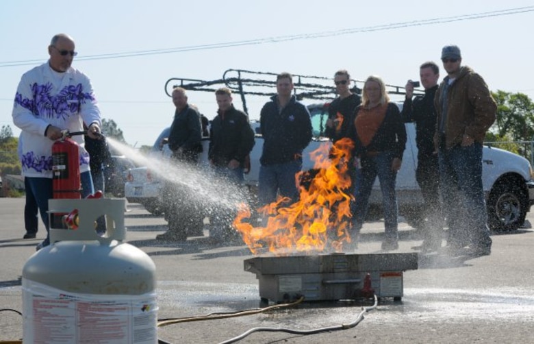 FOLSOM, Calif. -- Fred Strickland, an engineer with the U.S. Army Corps of Engineers Sacramento District, douses a ring of propane fire during a training exercise here, April 7, 2012. Strickland and nearly 20 Corps employees participated in yearly fire extinguisher safety training, mandated by Occupational Safety and Health Administration, and conducted by the district's safety office. The training included a video presentation, group discussion, followed by a timed live-fire exercise.