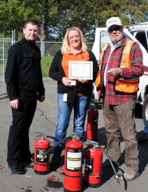FOLSOM, Calif. --(From left) Jason Walsh and Sue Fox, safety specialists; and Dan Williams, safety officer from the U.S. Army Corps of Engineers Sacramento District, prepare to award certificates of completion for the yearly fire extinguisher safety training here, April 7, 2012. The training, mandated by Occupational Safety and Health Administration and conducted by the district's safety office, included a video presentation, group discussion, followed by a timed live-fire exercise. 