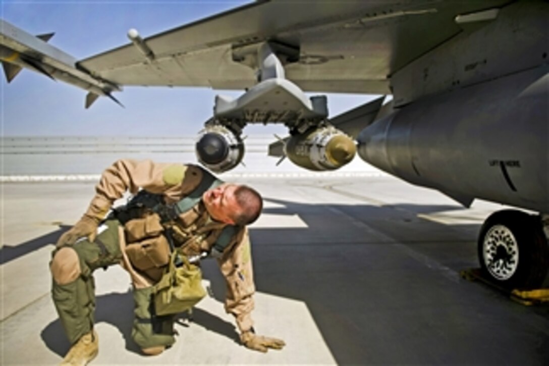 U.S. Air Force Maj. Todd Pierce inspects the bombs and missiles on an F-16C Fighting Falcon at Kandahar Airfield, Afghanistan, on April 5, 2012.  Pierce is an F-16C pilot assigned to the 451st Expeditionary Fighter Squadron.  