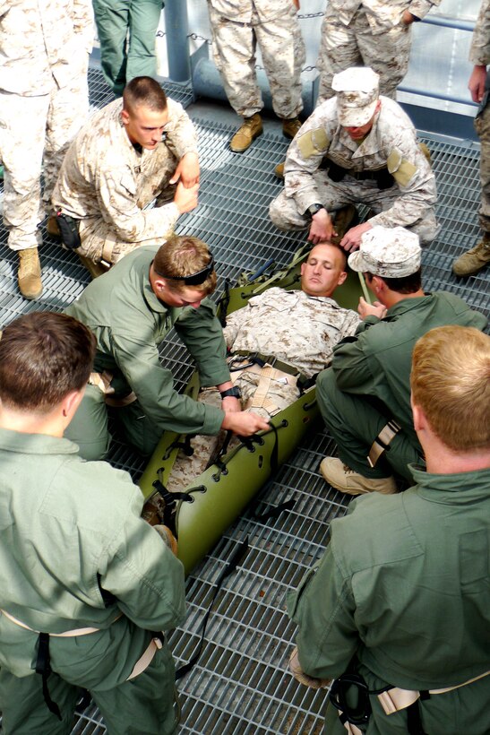 Servicemembers from the 15th Marine Expeditionary Unit’s Maritime Raid Force secure a simulated casualty during a casualty evacuation exercise at Naval Base San Diego, April 9. The MRF's primary role is to carry out raids against maritime objectives including gas and oil platforms, ships and targets on shore. This was the first time the MRF was able to practice their unique skill sets as a cohesive unit. (U.S. Marine Corps photo by Lance Cpl. Timothy Childers)