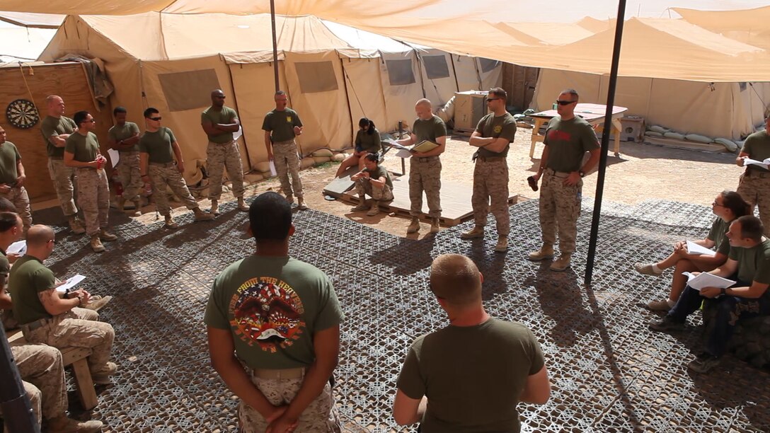 Sailors and Marines from the Shock Trauma Platoon and Forward Resuscitative Surgery System, Surgical Company, 1st Maintenance Battalion (-) Reinforced, 1st Marine Logistics Group (Forward) discuss roles and responsibilities during a scheduled mass casualty drill at the STP/FRSS at Forward Operating Base Edinburgh, Afghanistan, April 10. Shortly after the drill was completed, the sailors and Marines had multiple casualties in their care.