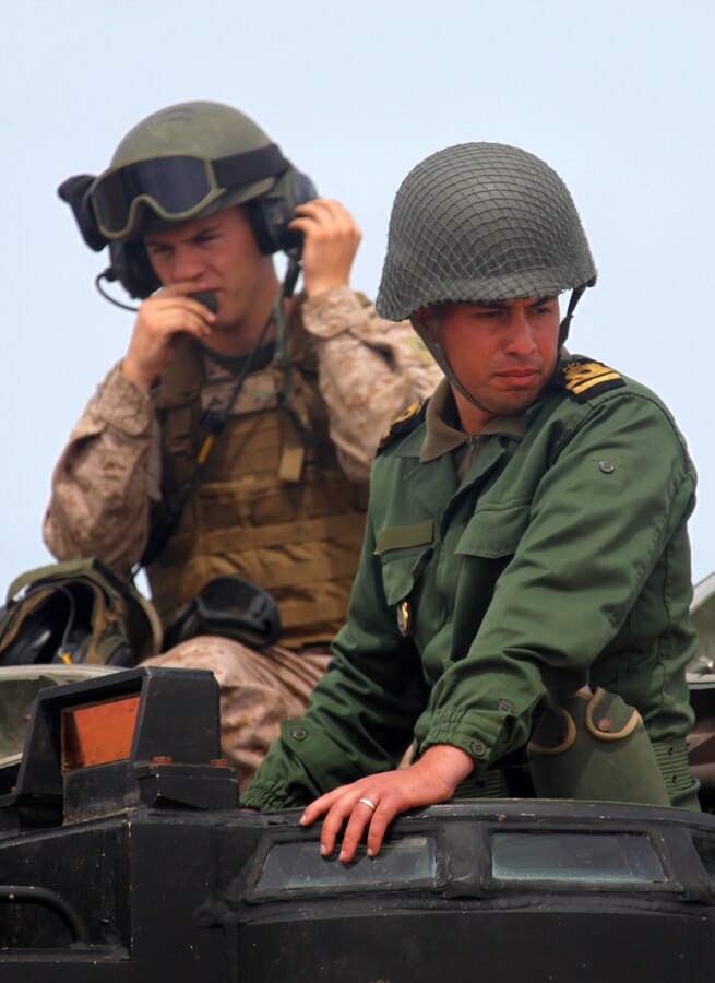 A member of the Royal Moroccan Armed Forces prepares to ride in an assault amphibious vehicle with Marines from Battalion Landing Team 1st Battalion, 2nd Marine Regiment, 24th Marine Expeditionary Unit during the bi-lateral training exercise African Lion 12 on the shores of Morocco, April 12, 2012. The training allowed the Marines to introduce the Moroccan troops to the unique capabilities of the assault amphibious vehicle that the Marines drove to the beach that morning from the USS New York off the coast of Morocco. This exercise is the first event for the 24th MEU and Iwo Jima Amphibious Ready Group, which deployed in March on a regularly scheduled deployment to serve as a theater reserve and crisis response force.