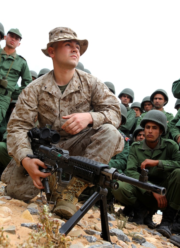 Pfc. William Justice, a machine gunner with Alpha Company, 1st Battalion, 2nd Marine Regiment, 24th Marine Expeditionary Unit, demonstrates gun drills for the members of the Royal Moroccan Armed Forces on a beach in Morocco during the bi-lateral training exercise called African Lion 12. This exercise is the first event for the 24th MEU and Iwo Jima Amphibious Ready Group, which deployed in March on a regularly scheduled deployment to serve as a theater reserve and crisis response force.