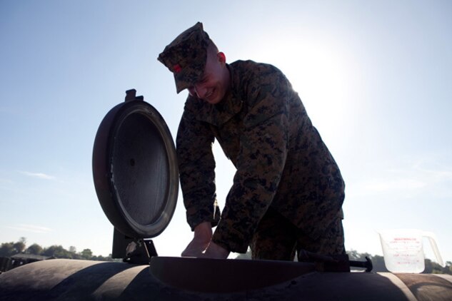 Lance Cpl. Collin M. Lowder, landing support specialist, Combat Logistics Regiment 37, fills up an M-149 water tank in Crow Valley, Philippines, in preparation for Exercise Balikatan 2012, April 11. The water was recovered from the local O'Donnell River and then filtered and purified by Marines using their Tactical Water Purification System.