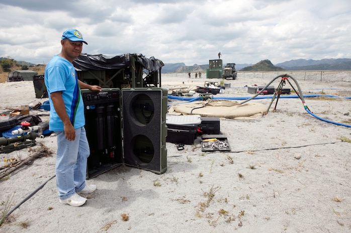 Philippine Army Staff Sgt. William B. Casta, command engineer, National Defense Support Command, checks on the Aspen 5500, an experimental water purification system used at Crow Valley in the Philippines for Exercise Balikatan 2012, April 11.