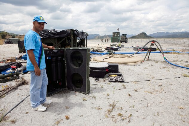 Philippine Army Staff Sgt. William B. Casta, command engineer, National Defense Support Command, checks on the Aspen 5500, an experimental water purification system used at Crow Valley in the Philippines for Exercise Balikatan 2012, April 11.