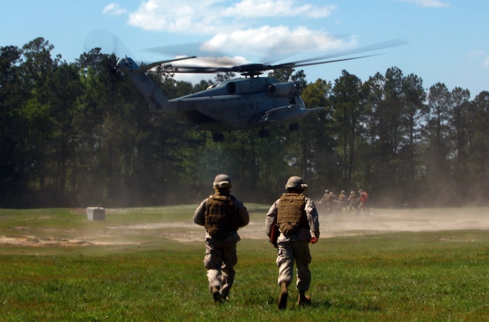 Marines with Landing Support Company, Combat Logistics Regiment 27, 2nd Marine Logistics Group latch simulated cargo to a CH-53E Super Stallion during helicopter support training at Landing Zone Kite aboard Camp Lejeune, N.C., April 11, 2012. The purpose of the exercise was to give the company’s Marines a chance to sharpen their knowledge of their military occupational specialty.