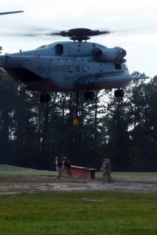 Marines with Landing Support Company, Combat Logistics Regiment 27, 2nd Marine Logistics Group latch simulated cargo to a CH-53E Super Stallion during helicopter support training at Landing Zone Kite aboard Camp Lejeune, N.C., April 11, 2012. The purpose of the exercise was to give the company’s Marines a chance to sharpen their knowledge of their military occupational specialty.