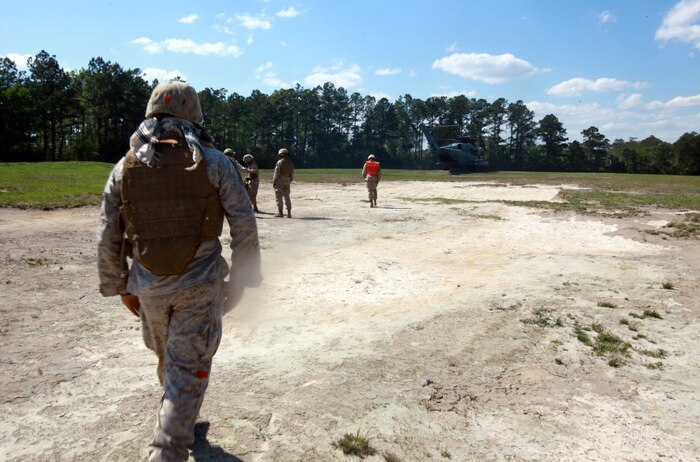 Marines with Landing Support Company, Combat Logistics Regiment 27, 2nd Marine Logistics Group prepare to latch simulated cargo to a CH-53E Super Stallion during helicopter support training at Landing Zone Kite aboard Camp Lejeune, N.C., April 11, 2012. The purpose of the exercise was to give the company’s Marines a chance to sharpen their knowledge of their military occupational specialty.