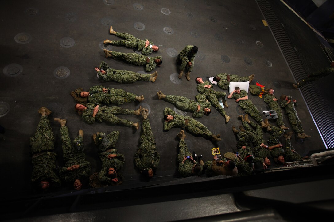 Sailors with 4th Amphibious Assault Battalion rest before well deck operations commence aboard USS Wasp, off the coast of Onslow Beach, N.C., April 11, 2012. The 26th Marine Expeditionary Unit is under way to support the commemoration of the Battle of New Orleans. Starting this April and continuing through 2015, the US Navy, US Marine Corps and US Coast Guard will commemorate the War of 1812 and the Star Spangled Banner. The War of 1812 celebration will commemorate the rich naval history and showcase the capabilities of today's Navy-Marine Corps Team.