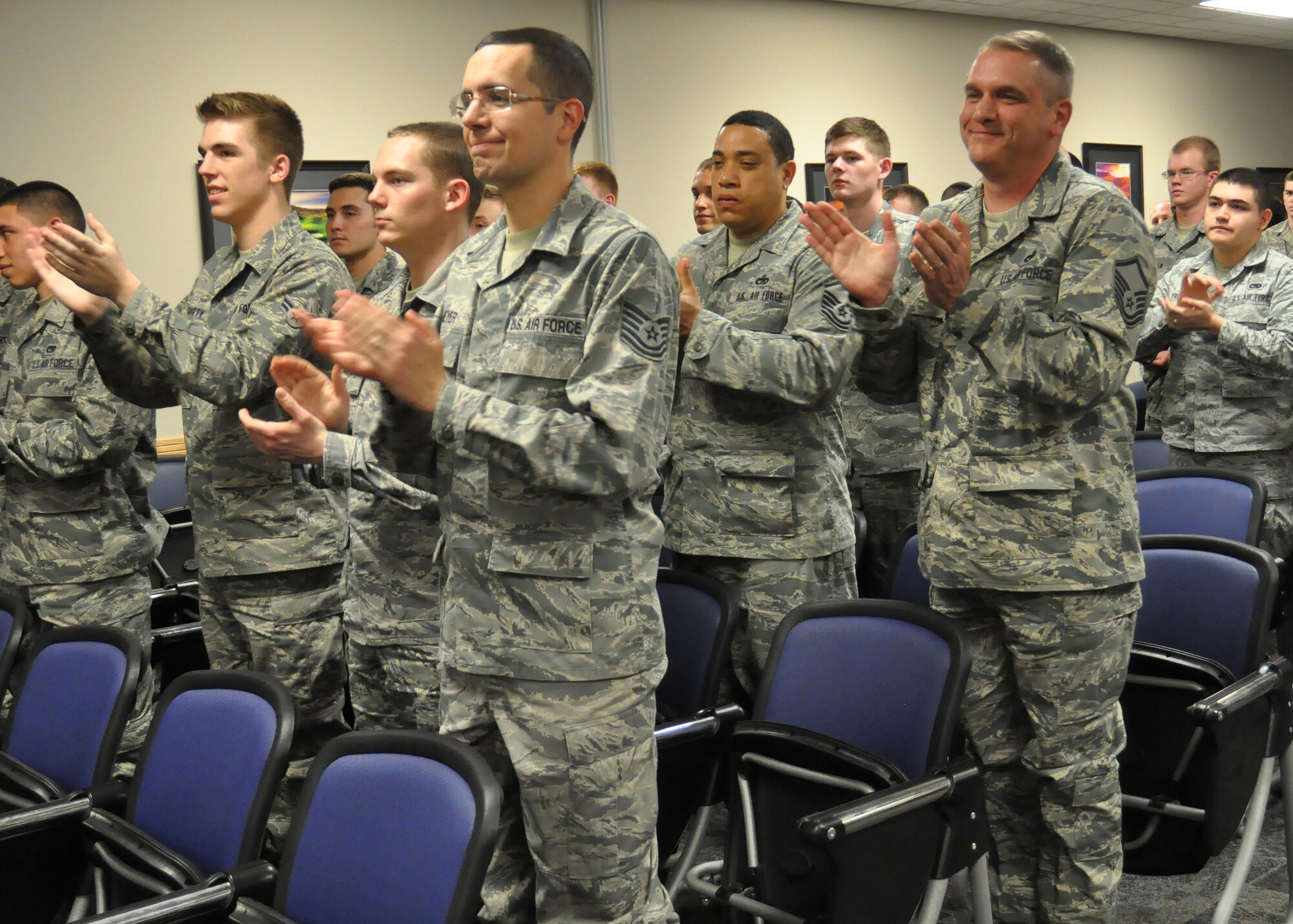 Airmen from the 62nd Aerial Port Squadron applaud Master Sgt. Scott Winchell during a Bronze Star ceremony April 11, 2012, at Joint Base Lewis-McChord, Wash. (U.S. Air Force photo/Senior Airman Leah Young)