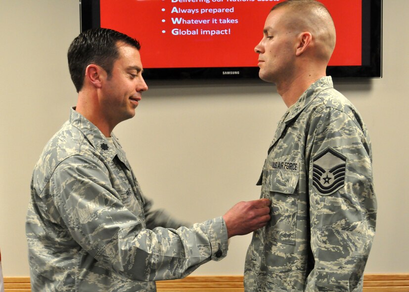 Lt. Col. Robert Farkas, left, 62nd Aerial Port Squadron commander, pins on Master Sgt. Scott Winchell’s Bronze Star during a ceremony April 11, 2012, at Joint Base Lewis-McChord, Wash. Winchell distinguished himself with exceptional meritorious service while during his fifth deployment while serving as the 19th Movement Control Team superintendent from August 2011 through March 2012. (U.S. Air Force photo/Senior Airman Leah Young)