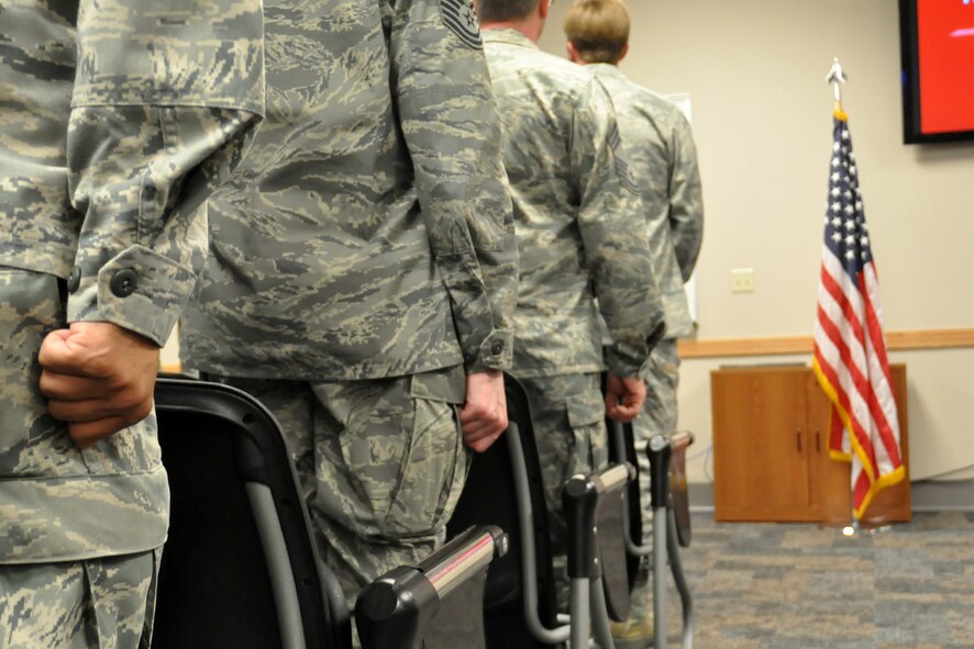 Airmen from the 62nd Aerial Port Squadron stand at attention during a Bronze Star ceremony honoring Master Sgt. Scott Winchell April 11, 2012, at Joint Base Lewis-McChord, Wash. (U.S. Air Force photo/Senior Airman Leah Young)