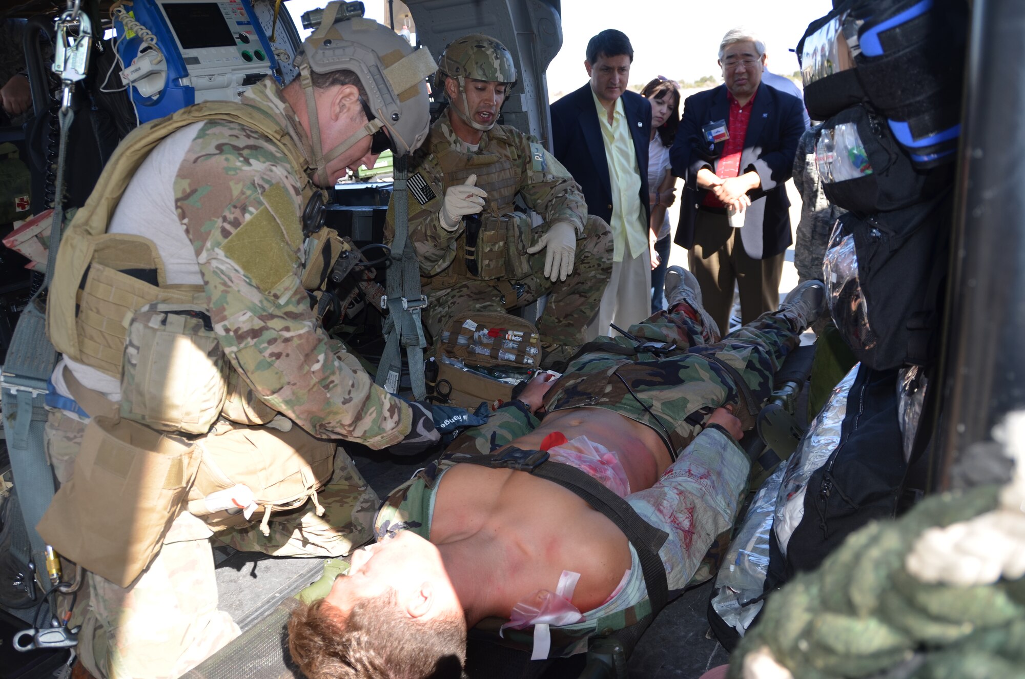 SSgt Maurice Sweet (forefront) and SSgt Ryan Gilbert, pararescuemen assigned to the 305th Rescue Squadron, demonstrate to civic leaders from San Antonio, Texas how they provide care to injured personnel after locating them in a combat area.  The civic leaders’ tour was hosted by the 433 Airlift Wing, Lackland Air Force Base, Texas. (U.S. Air Force photo by SMSgt Minnie Jones)
