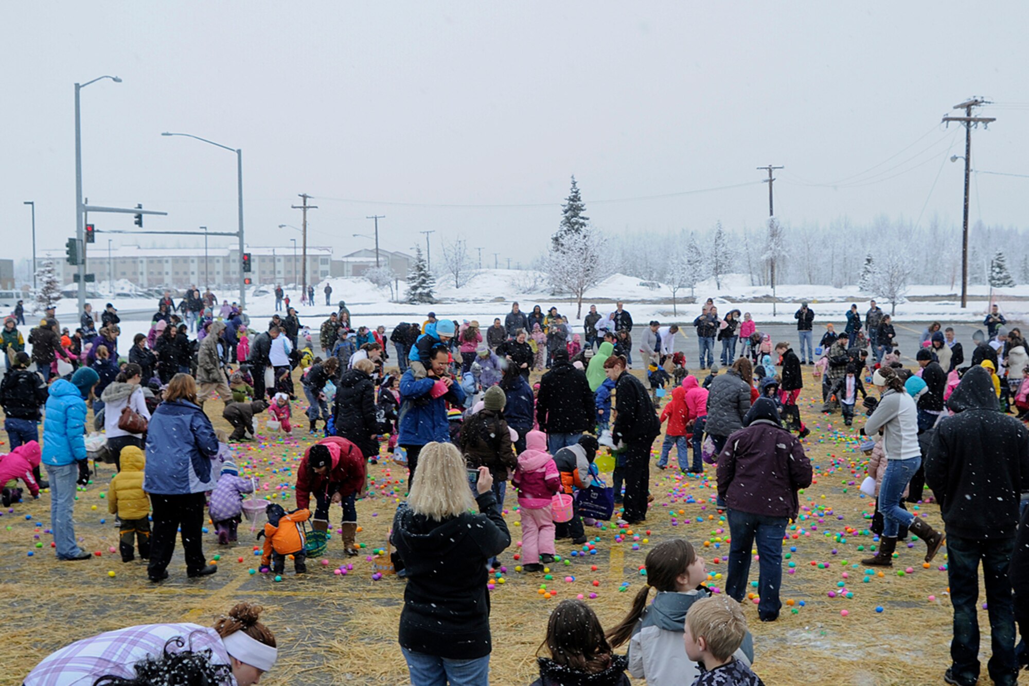 Parents and children run onto the field to begin the egg hunt durring the "Easter Eggstravaganza" on Joint Base Elmendorf-Richardson April 7, 2012. This was the first year that they combined the Air Force and Army Easter celebration and held it at Buckner gym. (U.S. Air Force photo/Staff Sgt. Zachary Wolf)