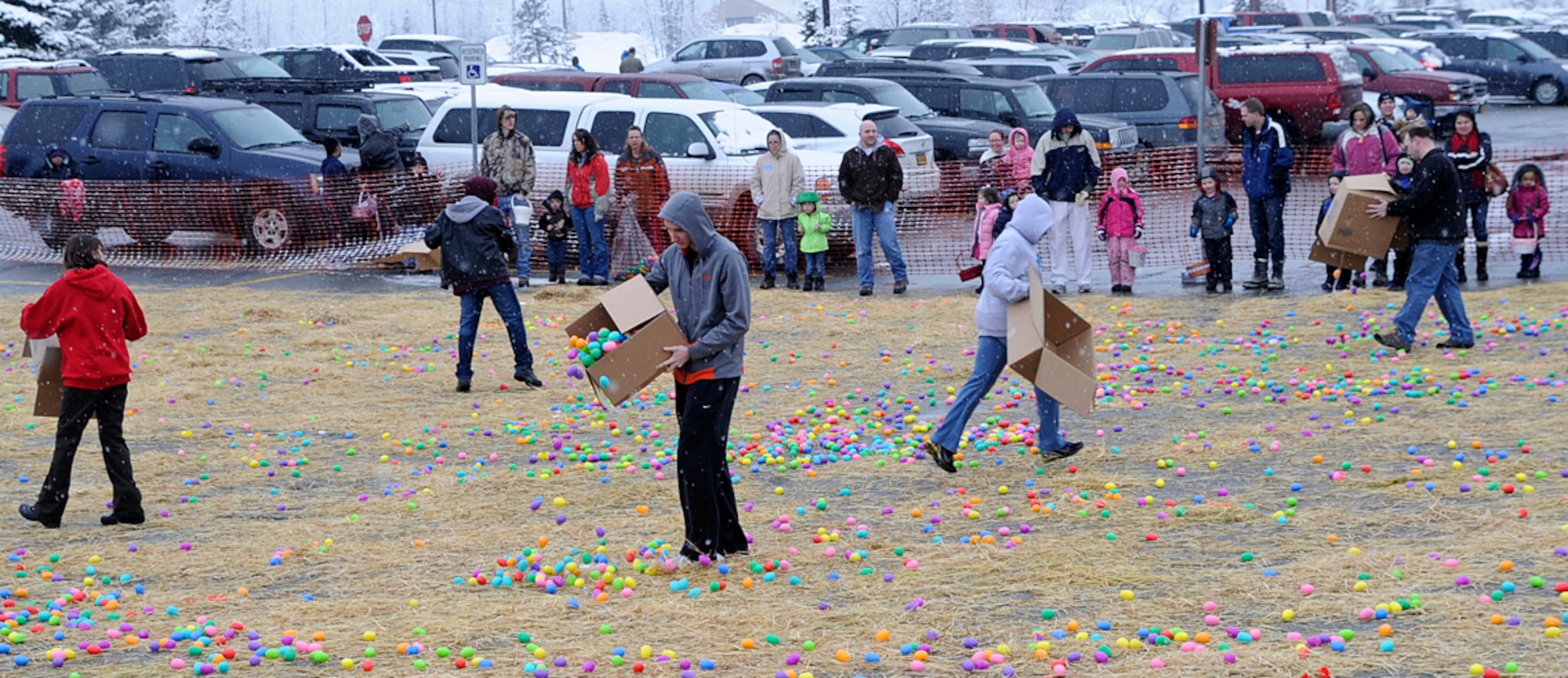 Volunteers dump out eggs before the egg hunt during the "Easter Eggstravaganza" on Joint Base Elmendorf-Richardson April 7, 2012. This was the first year that they combined the Air Force and Army Easter celebration and held it at Buckner gym. (U.S. Air Force photo/Staff Sgt. Zachary Wolf)