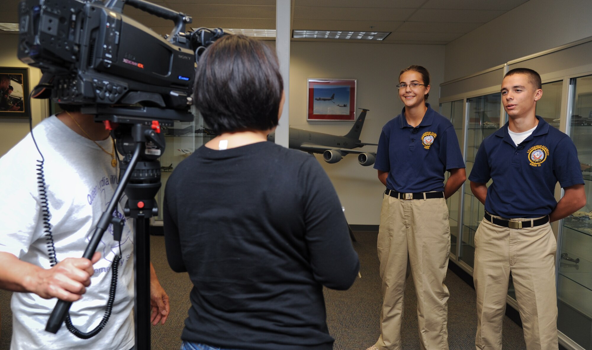 Junior Reserve Officer Training Corps cadets speak to the Hawaii State Department of Education public affairs about their experience while flying on a KC-135 Stratotanker from the 96th Air Refueling Squadron on Joint Base Pearl Harbor-Hickam, HI, April 5. The DOS filmed a brief news piece about the cadets' flight and the relationship between the local military and JROTC. (U.S. Air Force photo/Senior Airman Lauren Main)