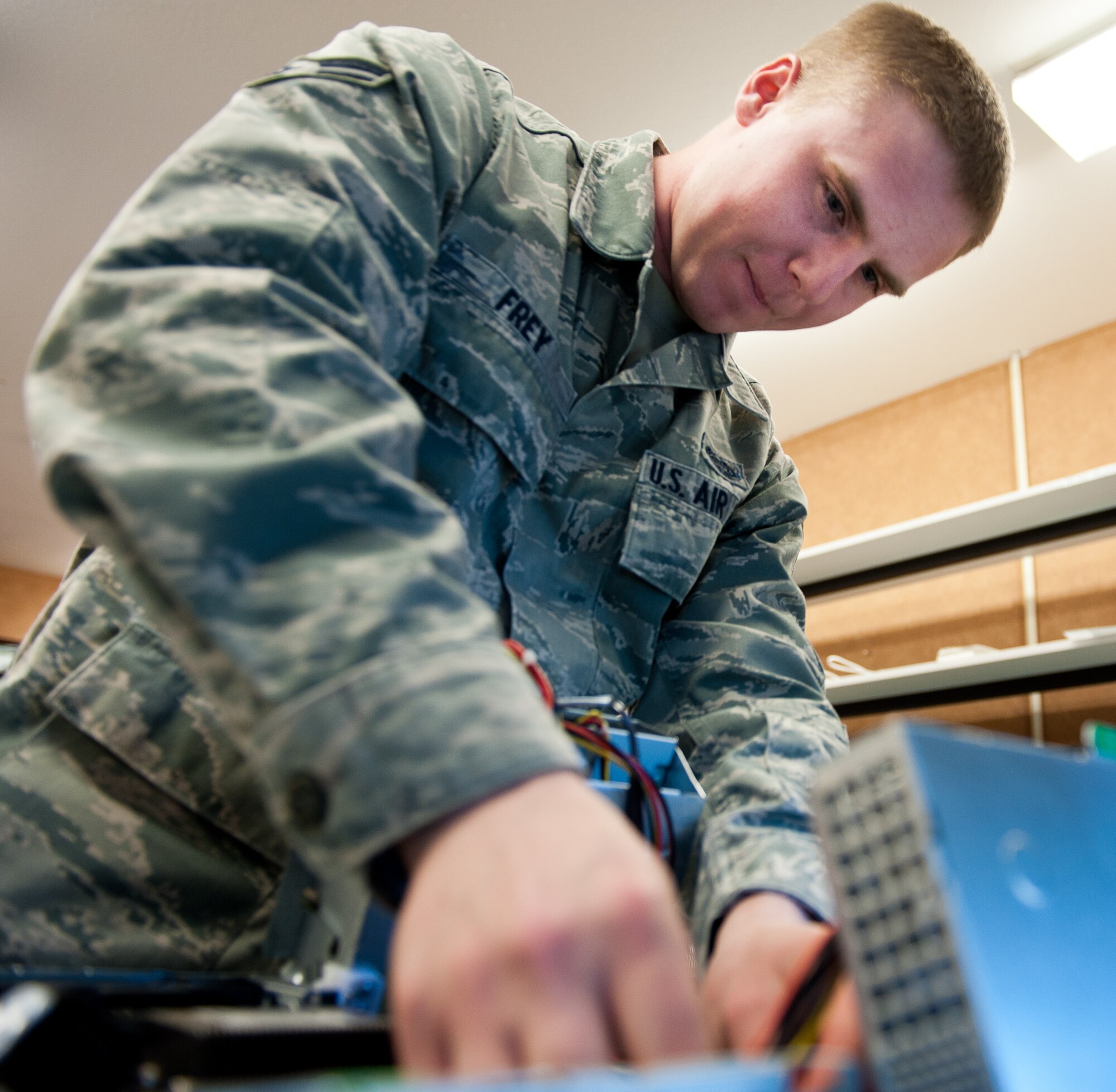 Airman 1st Class Corey Frey, 28th Communications Squadron client systems technician, unplugs wires inside a computer tower while troubleshooting a central processing unit at Ellsworth Air Force Base, S.D., April 4, 2012. Client systems technicians keep the network and systems operating by quick response and resolution of computer problems on base. (U.S. Air Force photo by Airman 1st Class Kate Thornton/Released)