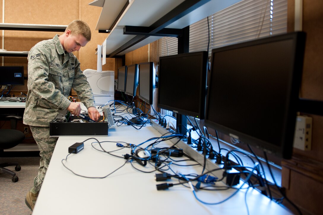 Airman 1st Class Corey Frey, 28th Communications Squadron client systems technician, disassembles a computer tower while troubleshooting a central processing unit at Ellsworth Air Force Base, S.D., April 4, 2012. Client systems technicians are responsible for assisting customers with account and computer problems, and ensuring uninterrupted computer-based operations on base. (U.S. Air Force photo by Airman 1st Class Kate Thornton/Released)