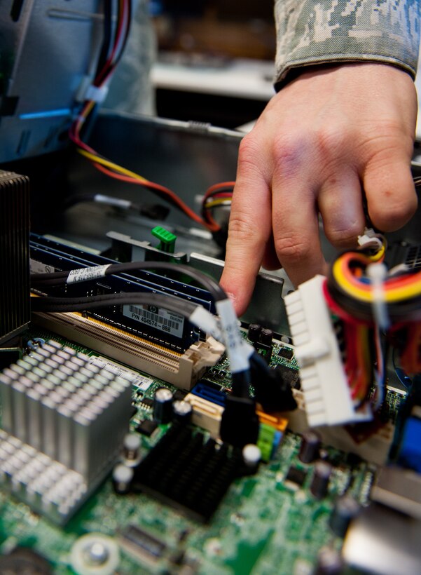 Airman 1st Class Corey Frey, 28th Communications Squadron client systems technician, removes memory from a computer tower while troubleshooting a problem at Ellsworth Air Force Base, S.D., April 4, 2012. When network or computer problems arise, client systems technicians troubleshoot and find solutions to bring systems online as quickly as possible. (U.S. Air Force photo by Airman 1st Class Kate Thornton/Released)