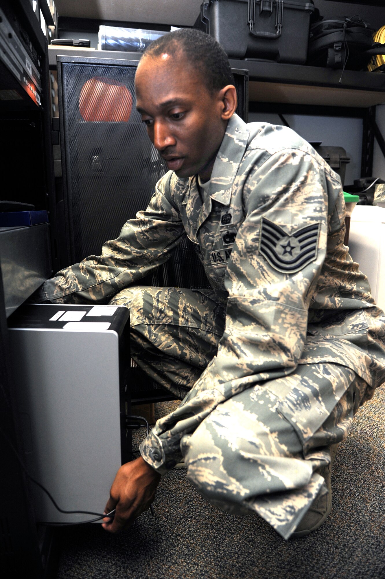 Tech. Sgt. Linell McKissick inspects a computer modem at Vance Air Force Base, Okla., during a routine help request. McKissick, with the 71st Communications Squadron, was named an April Warrior of the Week. (U.S. Air Force photo/ Airman 1st Class Frank John Casciotta)
