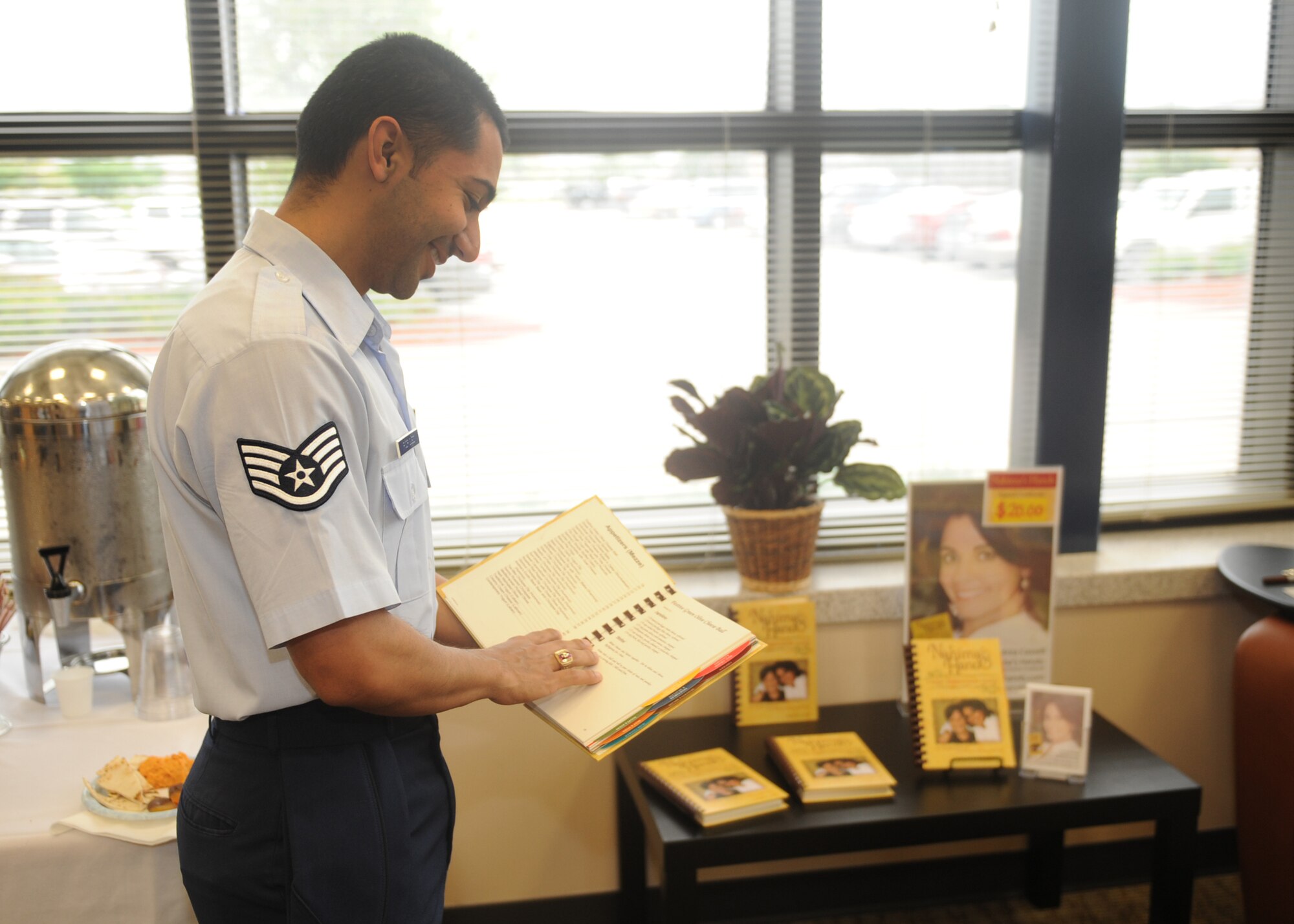 Staff Sgt. Martin Rodriguez, 349th Air Refueling Squadron boom operator, reviews a cookbook by Andrea Cassell during the Library Open House April 9, 2012, McConnell Air Force Base, Kan. The McConnell Library is hosting programs April 9 to 14, such as Mother Goose preschool story time, learn Spanish in one hour and the cultures and beliefs of Islam presentation to celebrate National Library Week. (U.S. Air Force photo/ Airman 1st Class Maurice A. Hodges)