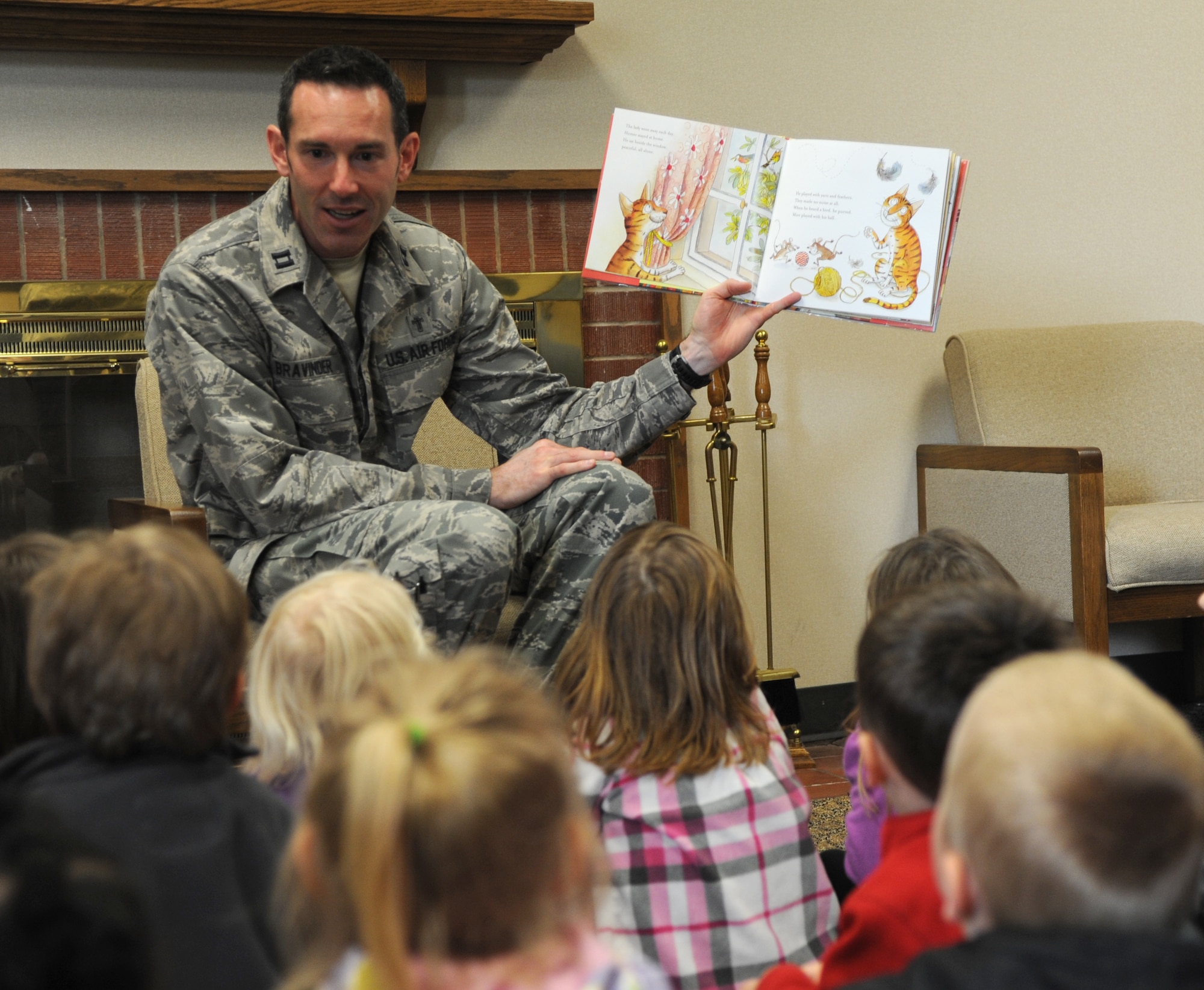 Chaplain (Capt.) Jon Bravinder, with the 71st Flying Training Wing, reads to children at the base library in honor of National Library Week at Vance Air Force Base, Okla. (U.S. Air Force photo/ Airman 1st Class Frank John Casciotta)