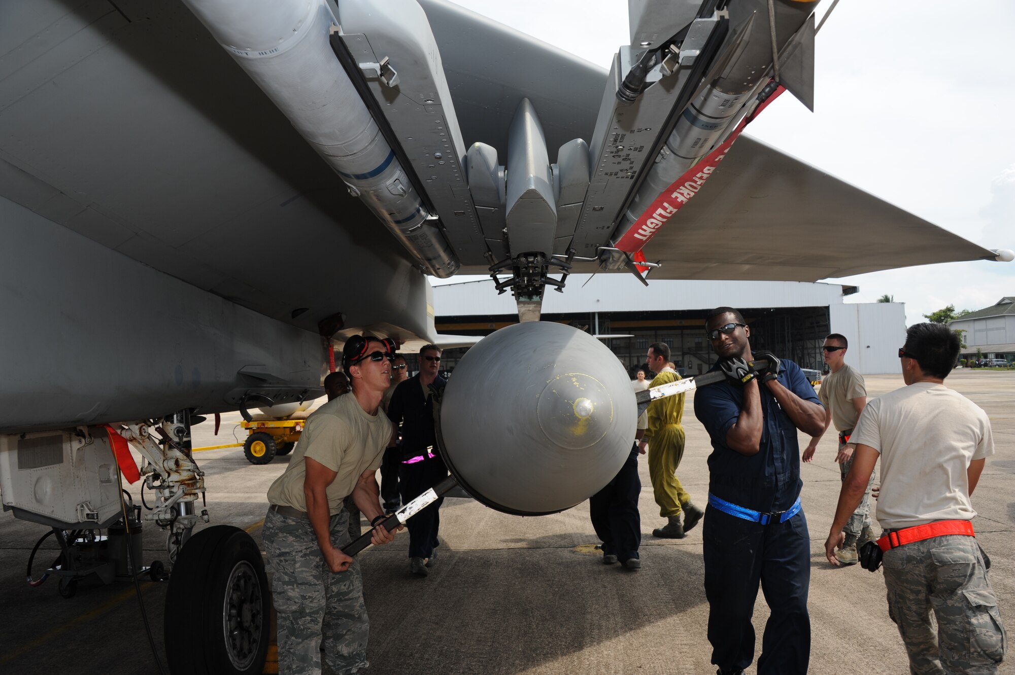 Airmen from the 67th Aircraft Maintenance Unit from Kadena Air Base, Japan,  prepare to install an auxiliary fuel tank on an F-15C during Cope Taufan 2012 at TUDM Butterworth April 9, 2012. The tank extends the range of the jet and allows it to fly extended-length sorties. Cope Taufan is a live-flying exercise designed around dissimilar basic fighter maneuvers and dissimilar air combat tactics training between the U.S. Air Force and Royal Malaysian Air Force. (U.S. Air Force photo/Master Sgt. Matt Summers)