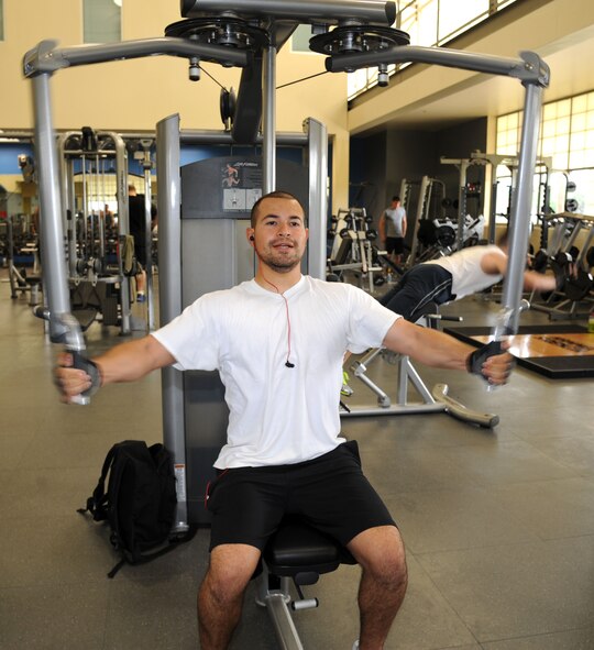Senior Airman Adrian Castillo, 2nd Security Forces Squadron, exercises his upper body at the fitness center on Barksdale Air Force Base, La., April 11. Physical fitness plays a large part in a service member's career, especially in a highly physical career field such as security forces. Castillo works out at least once a day to maintain fitness standards. Many Airmen utilize the fitness center to take advantage of the amenities such as weights, basketball courts and outdoor and indoor tracks (U.S. Air Force photo/Airman 1st Class Andrew Moua)(RELEASED)