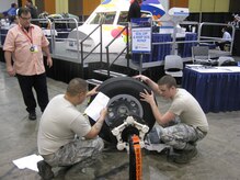 Staff Sgt. Sean Nappier and Senior Airman Kevin Meredith work together during the wheel and brake competition as a judge watches during the Aircraft Maintenance Technology Skills Competition March 7 through 9 in Las Vegas. The two played a key role in helping the “Ace’s of Maintenance” take first in the event. Nappier is a 437th Aircraft Maintenance Squadron avionics technician and Meredith is a 437th Maintenance Squadron aerospace propulsion journeyman. (Courtesy photo)