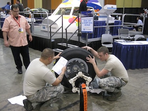 Staff Sgt. Sean Nappier and Senior Airman Kevin Meredith work together during the wheel and brake competition as a judge watches during the Aircraft Maintenance Technology Skills Competition March 7 through 9 in Las Vegas. The two played a key role in helping the “Ace’s of Maintenance” take first in the event. Nappier is a 437th Aircraft Maintenance Squadron avionics technician and Meredith is a 437th Maintenance Squadron aerospace propulsion journeyman. (Courtesy photo)