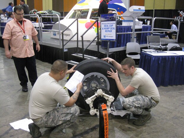 Staff Sgt. Sean Nappier and Senior Airman Kevin Meredith work together during the wheel and brake competition as a judge watches during the Aircraft Maintenance Technology Skills Competition March 7 through 9 in Las Vegas. The two played a key role in helping the “Ace’s of Maintenance” take first in the event. Nappier is a 437th Aircraft Maintenance Squadron avionics technician and Meredith is a 437th Maintenance Squadron aerospace propulsion journeyman. (Courtesy photo)