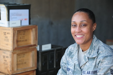 Senior Airman Caprice Frazier takes a moment for a photo after taking inventory at Joint Base Charleston - Air Base Munitions Center April 10. The 437th Maintenance Group Munitions office is responsible for more than $15 million dollars worth of munitions. Frazier is a munitions accountability technician with the 437th MXG. (U.S. Air Force photo/Staff Sgt. Katie Gieratz)
