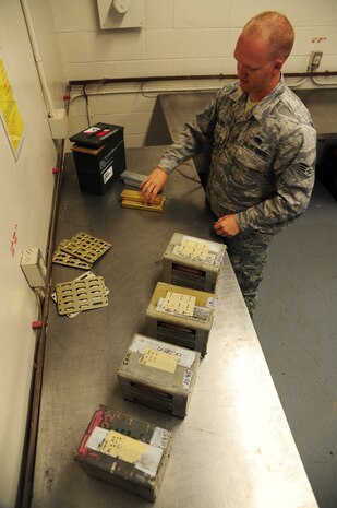 Senior Airman David Collins processes flares at the Joint Base Charleston - Air Base Munitions Center April 10. Flares are used on aircraft to deter incoming bombs. Collins is a munitions control technician with the 437th Maintenance Group Munitions office. (U.S. Air Force photo/Staff Sgt. Katie Gieratz) 
