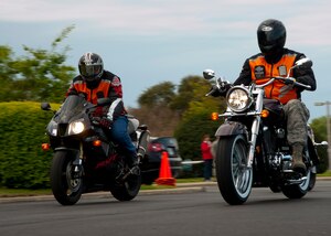 Two motorcyclists drive out during the Sexual Assault Prevention Response Awareness Month Road Rally April 6 at the Langley Air Force Base, Va., Community Activity Center. More than 20 members of the Joint Base Langley-Eustis community participated in the event. (U.S. Air Force photo by Senior Airman John D. Strong II/Released)
