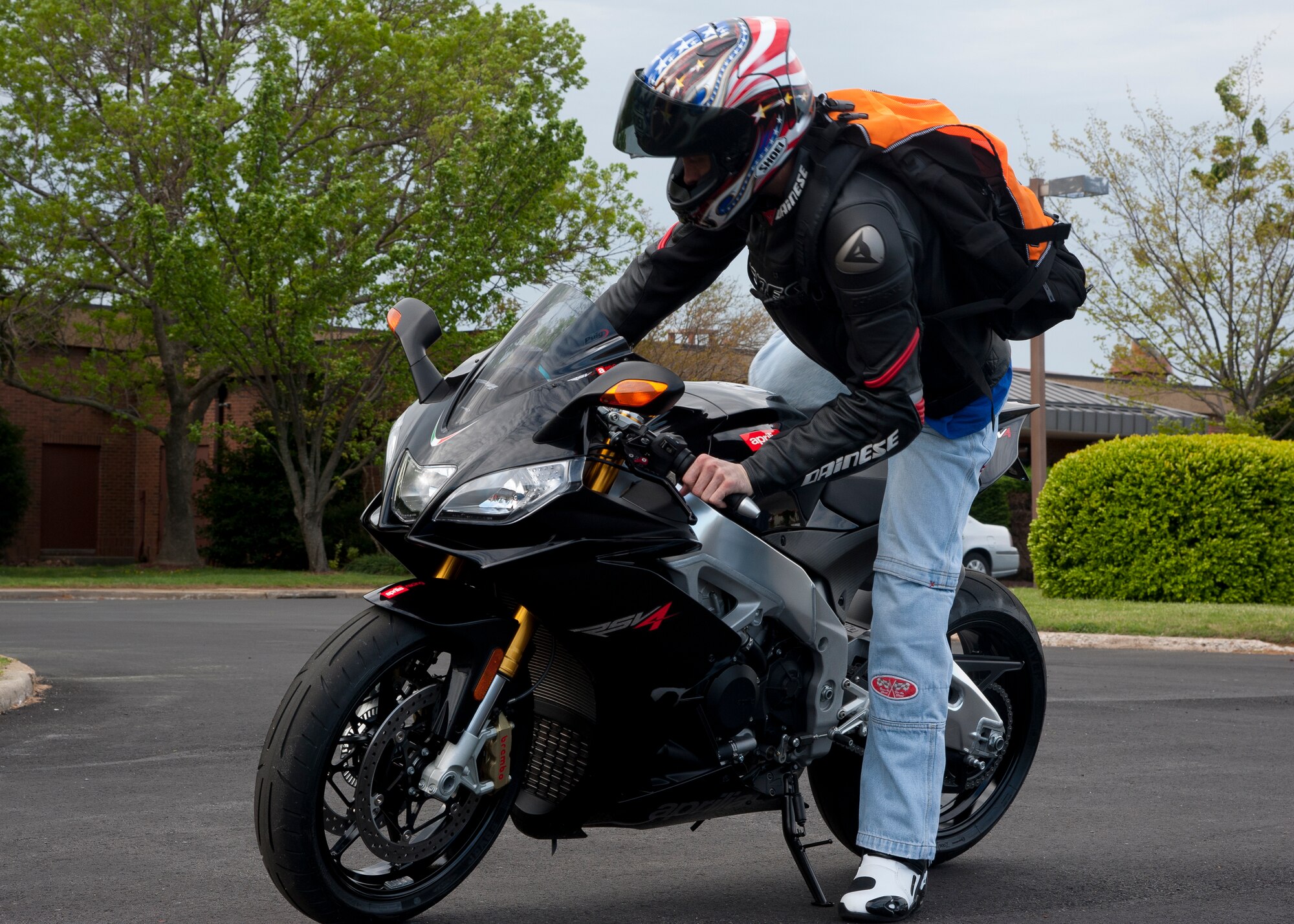 U.S. Air Force Master Sgt. Robert Medivilla, 633rd Medical Group first sergeantr, mounts his Aprillia RSV-4 during the Sexual Assault Prevention Response Awareness Month road rally April 6 at the Langley Air Force Base, Va., Community Activity Center. Medivilla served as the lead road captain for the ride. (U.S. Air Force photo by Senior Airman John D. Strong II/Released)