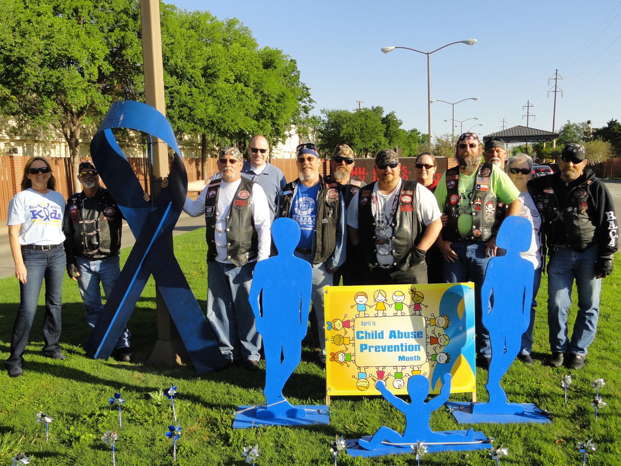 Sheppard Family Advocacy Program members and Bikers Against Child Abuse pose in front of a display in honor of Child Abuse Awareness Month, April 1, 2012, with this year’s theme as “Stand Up For Children.” For more information on child abuse reporting and prevention please call the Sheppard Family Advocacy Program office at 940-676-2271.