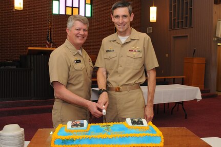 Capt. Tom Bailey, left, and Capt. Ralph Ward cut the ceremonial cake during a routine change of command ceremony at Naval Support Activity Charleston at the Good Shepherd Chapel at Joint Base Charleston – Weapons Station, April, 10. Bailey relieved Ward as the NSA commanding officer and as JB Charleston joint base deputy commander.  Ward will retire April 13 after 30 years of service. (U.S. Navy photo/ Petty Officer 1st Class Jennifer Hudson)