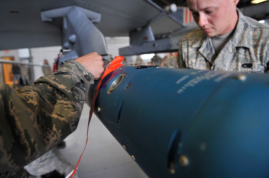 U.S. Air Force Senior Airman Eric Perkins,79th Aircraft Maintenance Unit weapons specialist, loads an air intercept missile-9 L/M onto an F-16 Fighting Falcon at Shaw Air Force Base, S.C., April 6, 2012. Perkins along with other Airman were competing in a quarterly load crew competition.(U.S. Air Force photo by Airman Nicole Sikorski/Released)