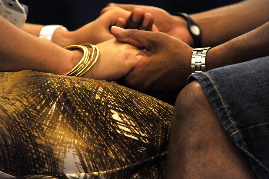 HILTON HEAD, S.C. - U.S. Air Force Staff Sgt. James Thomason, Jr., a logistics craftsman assigned to the 20th Logistics Readiness Squadron, and his wife Marisol hold hands during a "Knee-to-Knee" exercise during a marriage retreat at the Crowne Plaza Hotel in Hilton Head, S.C. on March 31, 2012. Thomason and his wife have been married for two years and thought this was a good chance to concentrate on each other away from the base. They joined19 other couples in attending a three-day marriage care seminar sponsored by the chaplain corps of Shaw Air Force Base, S.C.  (U.S.  Air Force photo by Master Sgt. Cohen A. Young/Released)