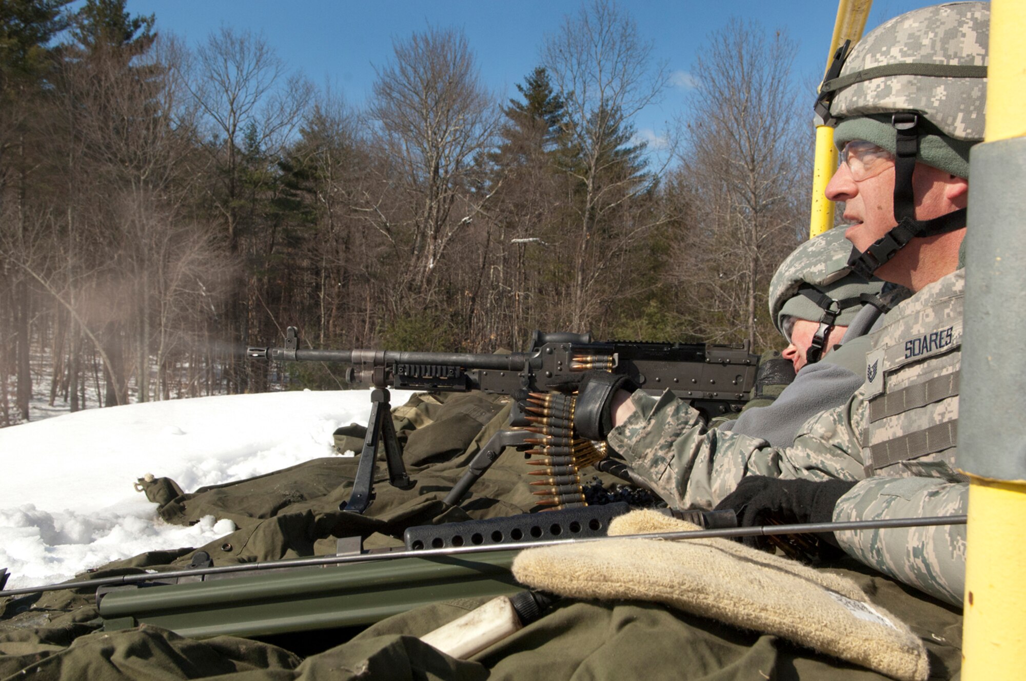 FORT DEVENS, Mass. -- (left to right) Staff Sgt. Brett Peterson and Tech.
Sgt. Philip Soares, both 157th Security Forces Squadron Combat Arms Training
and Marksmanship (CATM) personnel, fire weapons prior to a live fire
training mission on the M240B and M249 weapon systems on the range here Mar.
5. (National Guard photo by Tech. Sgt. Mark Wyatt/RELEASED)
